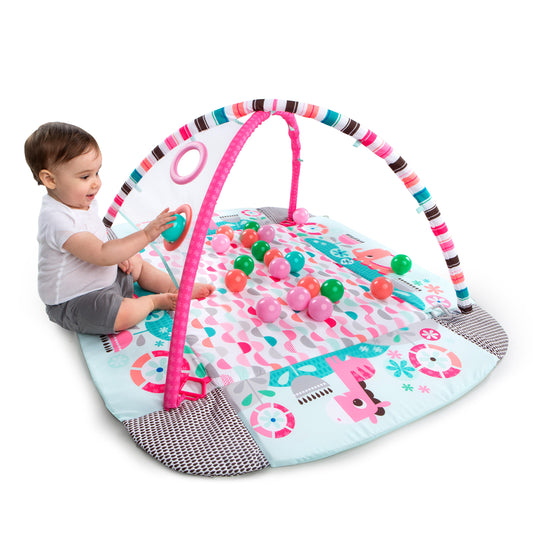 "5-in-1 activity gym voor baby met roze speeltjes, boogjes en openzetbare ophoogstaande randen."